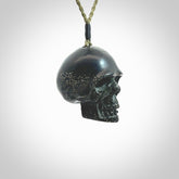 This picture shows a large sized Snowflake Obsidian stone skull pendant that we have hand carved. It is polished to a soft shine and is a very striking piece. Provided with an adjustable khaki cord.